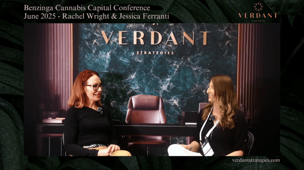 Rachel Wright and Jessica Ferranti sit across from each other in a professional interview setup at the Benzinga Cannabis Capital Conference in June 2025. Behind them, a green marble Verdant Strategies backdrop with gold lettering is visible.
