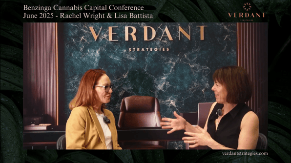 Rachel Wright and Lisa Farrell Battista sit across from each other during an interview at the Benzinga Cannabis Capital Conference in June 2025, with a Verdant Strategies green marble backdrop behind them.