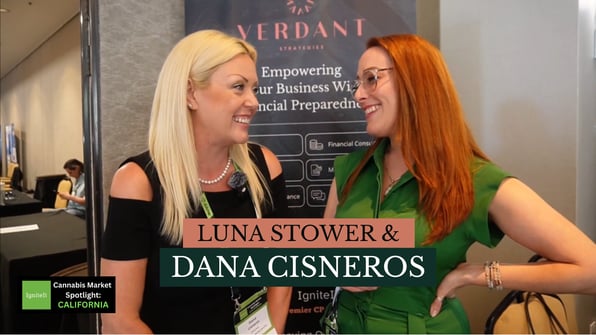 Luna Stower and attorney Dana Cisneros smile and talk together at the Verdant Strategies booth during the IgniteIt Cannabis Market Spotlight in California. A Verdant banner with the slogan “Empowering Your Business with Financial Preparedness” appears in the background.
